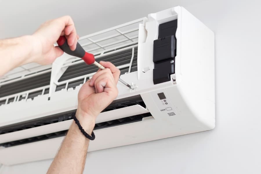 a technician installing an air conditioner