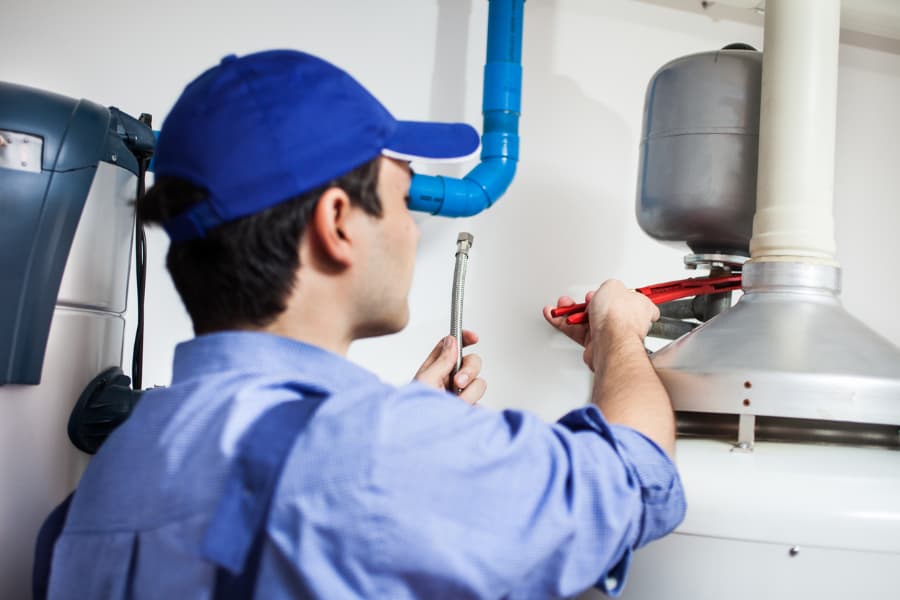 Trained technician performing maintenance services on boiler  