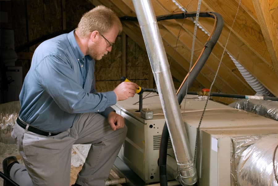 man working on furnace