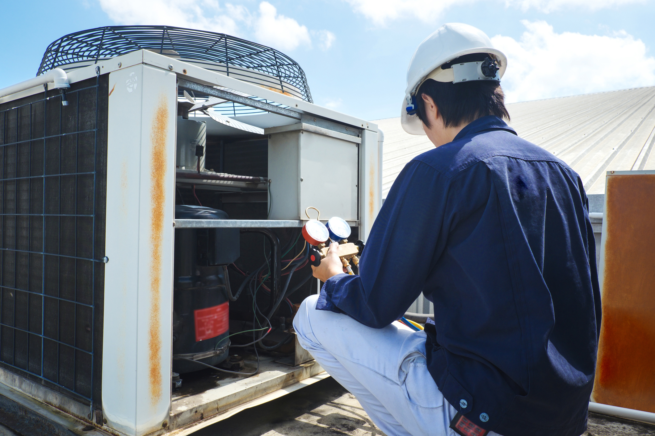 A Technician Repairing An Air-Conditioning Unit