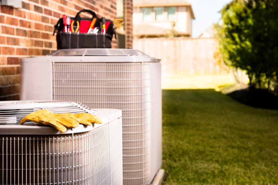 Work tools on air conditioners outside residential home